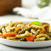 Pesto Pasta with Roasted Vegetables (Vegetarian) 2 cups cherry tomatoes, halved 2 cups chopped zucchini 2 cups chopped bell peppers 1/4 cup olive oil Salt and pepper, to taste 10 cups cooked pasta 2 cups store-bought or homemade pesto Preheat oven to 400°F. Toss cherry tomatoes, zucchini, and bell peppers with olive oil, salt, and pepper. Spread on a baking sheet and roast for 20-25 minutes, until vegetables are tender. Toss cooked pasta with pesto and roasted vegetables, and serve.